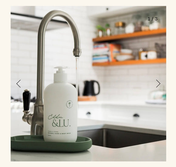 White bottle with 'Eldre & Lu' branding on a kitchen counter next to a faucet.