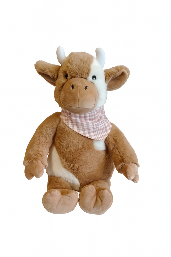 Plush toy cow with a checkered scarf on a white background