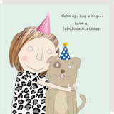 Illustration of a person hugging a dog with birthday hats on a light blue background.