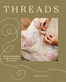 Book cover of 'Threads' with hand embroidery design on fabric