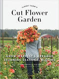 A cover image of the book titled 'Cut Flower Garden' showing a person with a basket of flowers standing in a field of blossoms.